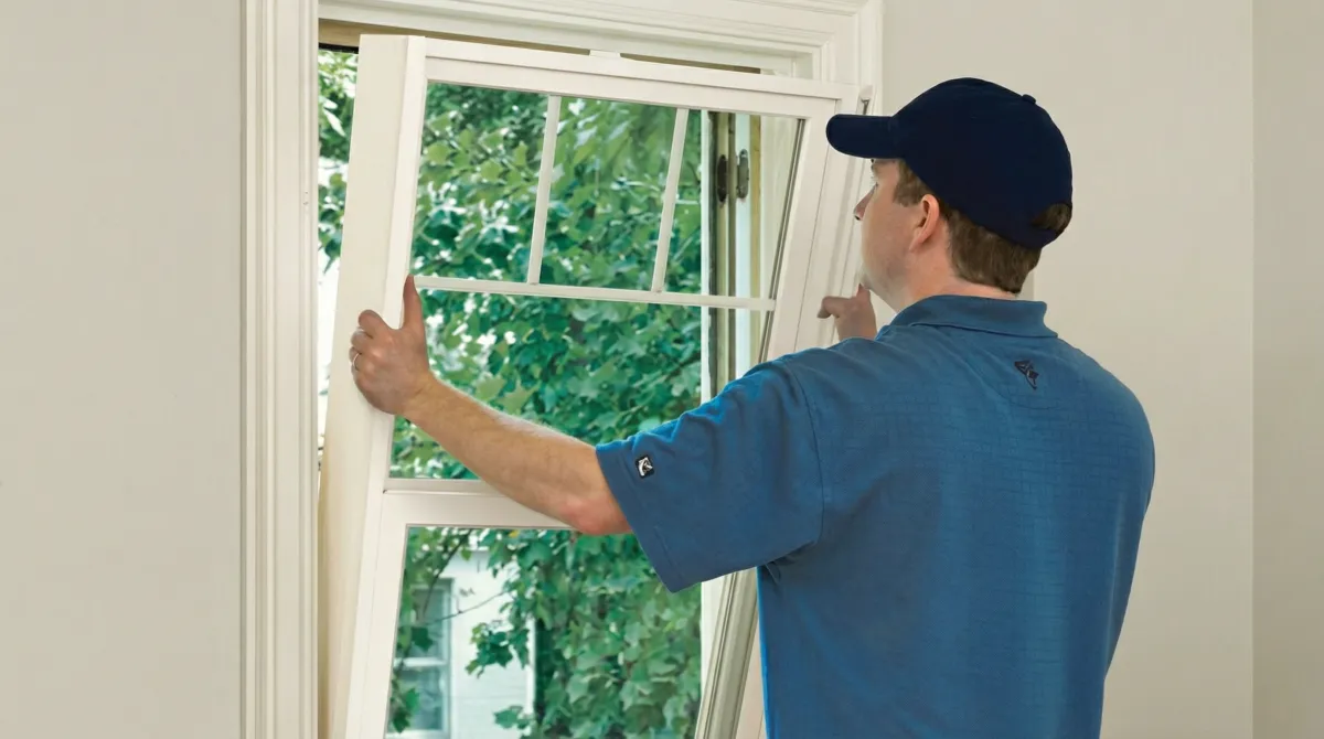Professional contractors performing a residential window insulation and replacement service in Birmingham, AL